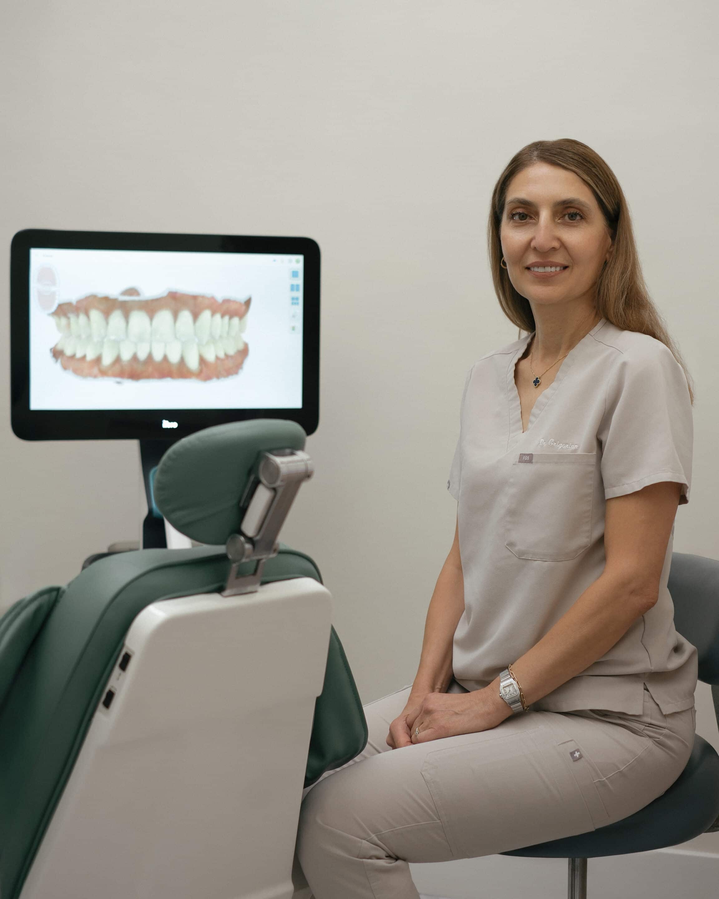 A dentist sitting next to a dental chair.